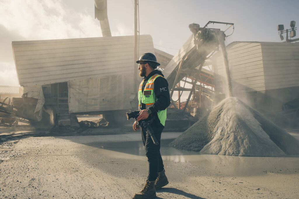 Photo of media core team member shooting video for aggregate company